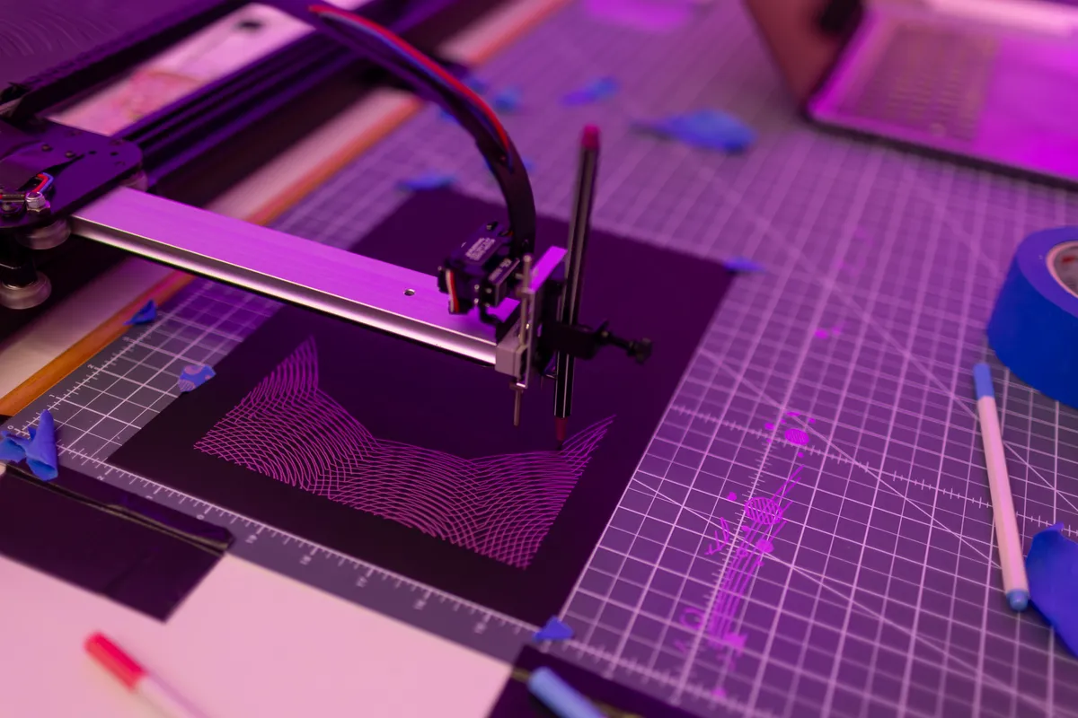 Pen plotter drawing a generative pattern at the WIAI25 celebration